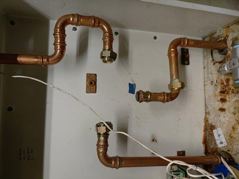 Diagnosed issue with Bradford White tanked water heater system. Identified faulty actuator affecting proper operation. Inspected dual-tank installation with copper piping network and examined connections for signs of water damage. Repaired actuator to restore normal functionality.