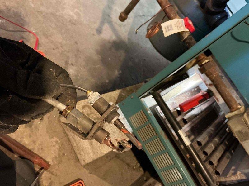 Responded to emergency no-heat call for a teal/green furnace system. Inspected the heat exchanger, copper piping connections, and pump motor assembly. Diagnosed and resolved issue with the expansion tank and associated valves to restore proper heating function.