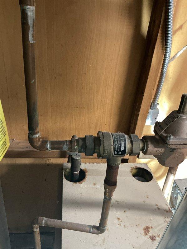 Performed scheduled maintenance on 20-year-old boiler system. Inspected and cleaned copper components including filters/tubing and examined pressure regulator assembly. System operational after service with no major issues detected.