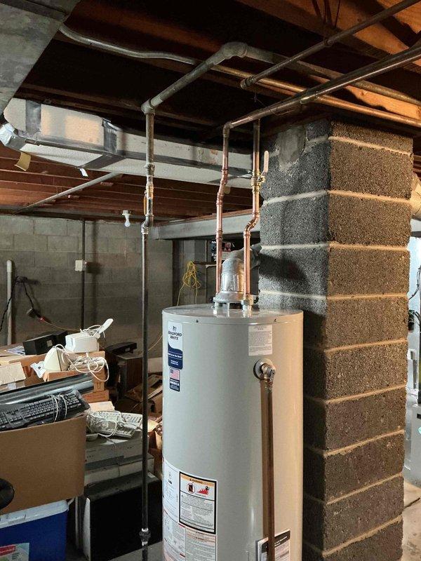 Responded to emergency service call for leaking Bradford White hot water tank in 74-year-old home. Upon inspection in basement utility area, identified tank failure requiring complete replacement. Successfully installed new water heater, connected existing copper supply lines, and verified proper operation with no leaks.