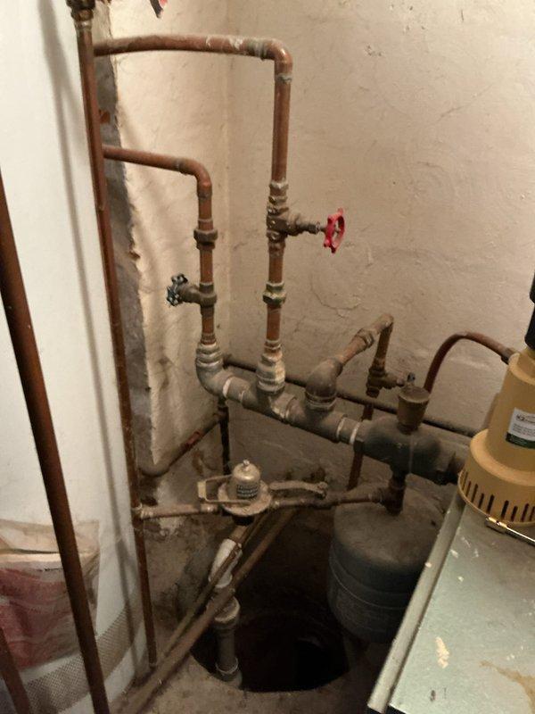 Diagnosed 20+ year old Pennco boiler system with insufficient heat delivery to baseboard radiators despite audible water flow. Inspection revealed aging copper pipes with significant scale buildup and a deteriorated circulation pump. Cleaned primary heat exchanger, replaced circulation pump, and flushed system to remove sediment. System now producing adequate heat throughout all zones.