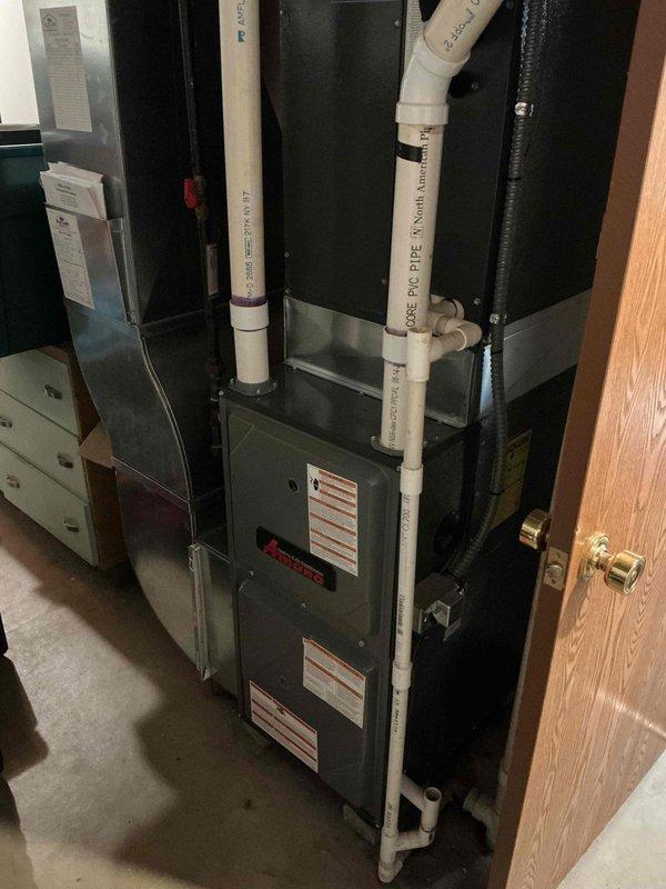 Performed routine maintenance service on 16-year-old natural gas furnace. Inspected full system including PVC venting pipes, access panels, and drainage configuration. Unit is functioning properly with no issues identified during this scheduled 9-1 heating maintenance visit.