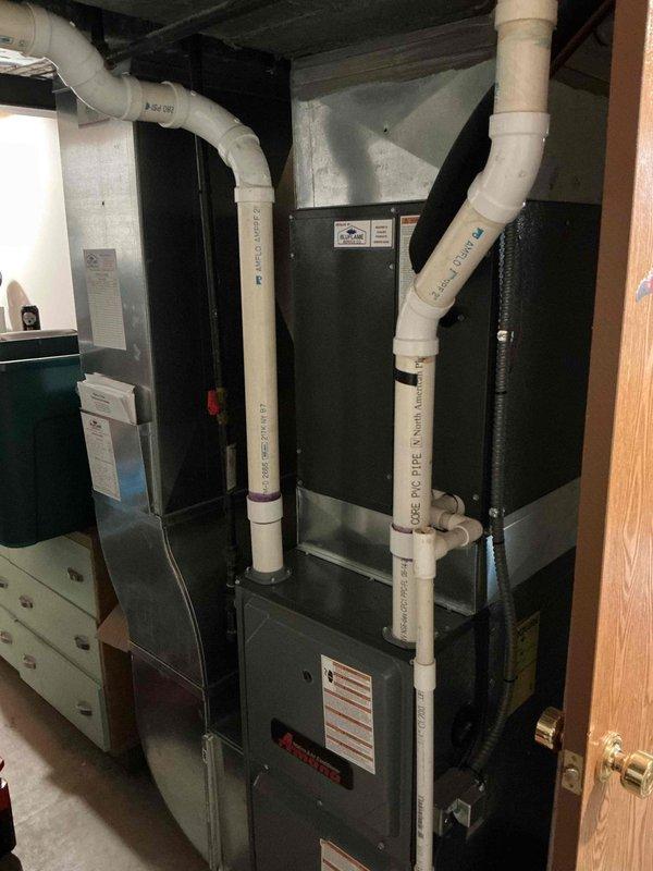 Performed routine maintenance service on 16-year-old natural gas furnace. Inspected full system including PVC venting pipes, access panels, and drainage configuration. Unit is functioning properly with no issues identified during this scheduled 9-1 heating maintenance visit.