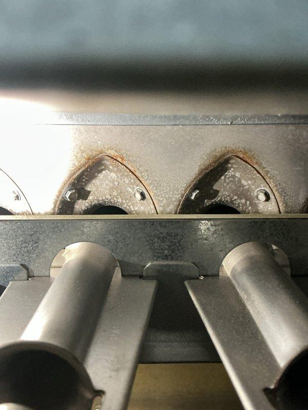 Responded to no heat call for furnace of unknown age. Upon inspection, found significant corrosion and rust on heat exchanger with visible deterioration around burner assembly openings. Determined heat exchanger failure was causing system shutdown. Recommended replacement of heat exchanger or full system replacement based on severity of corrosion and safety concerns.