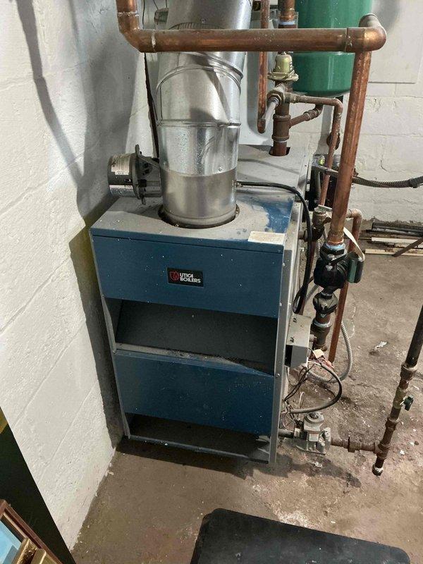 Responded to no heat call for Utica boiler system. Diagnostics revealed boiler temperature was significantly low (approximately 20-30°F) indicating system failure to maintain proper operating temperature. Inspected copper piping network, exhaust venting, and associated components; restored proper heating function by adjusting pressure settings and performing system reset.