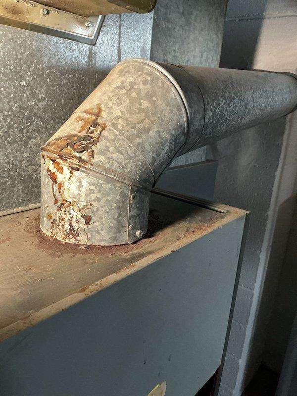 Performed scheduled furnace tune-up service per SC #891-5. Inspection revealed significant rust and corrosion on burner ports and galvanized ductwork, particularly at the elbow joint connection point. Cleaned accessible components and advised customer about deteriorating condition of system components that may require replacement in the future.