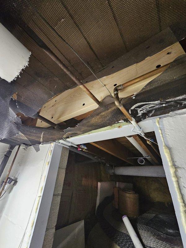 Responded to install callback to address multiple warranty items. Corrected HVAC installation issues including repositioning water heater to ensure proper clearance from furnace, installing expansion tank, routing condensate lines to sump pump, repairing humidifier control system, and securing termination boots on refrigerant lines. Also addressed structural concerns with cut joists and repaired filter rack to eliminate air leakage at the return.