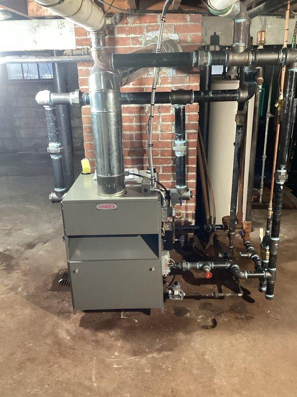 Successfully installed a 225kBtu steam boiler system in basement utility area. Completed comprehensive piping installation including exhaust flue, black PVC pipes, and copper supply lines with appropriate valves and fittings. System was properly connected to existing distribution network and verified for correct operation.