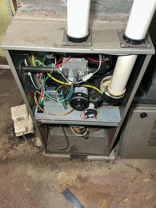 Responded to no-heat call for 10+ year old furnace. Upon inspection, found damaged hex tool and accessed interior components to diagnose issue. Serviced blower motor assembly and control board connections, checking all electrical wiring (red, yellow, green, blue, white) for proper function. System restored to normal operation.