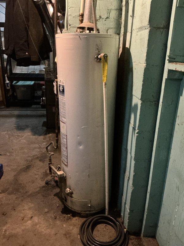 Performed standard furnace tune-up service as requested by customer. Inspected water heater system located in basement utility room against cinder block wall. System appears to be functioning normally with proper connections to copper pipes, gas line, and pressure relief valve. No immediate issues requiring attention were identified during the service visit.