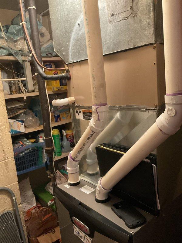 Conducted comprehensive HVAC replacement estimate, documenting existing furnace/air handler system with PVC venting in utility room and examining exterior equipment currently winterized with protective cover. Assessment included evaluation of current ductwork configuration and exterior utility connections to determine optimal replacement options.