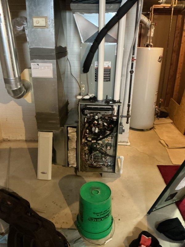 Performed routine maintenance tune-up on 10+ year old natural gas furnace, including inspection of gas valve connections and wiring. Accessed internal components by removing front panel to evaluate system condition, with particular attention to electrical connections and combustion controls. System was returned to service in proper working order with all panels secured.