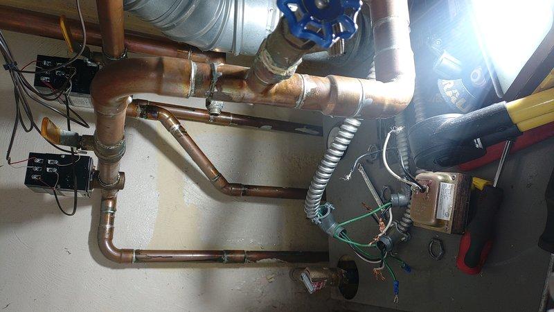 Responded to callback regarding aquastat issue. Retrieved replacement part from shop, installed new aquastat on customer's heating system. Verified proper operation of control panel and inspected copper piping network, which showed normal oxidation. System now operating within parameters.