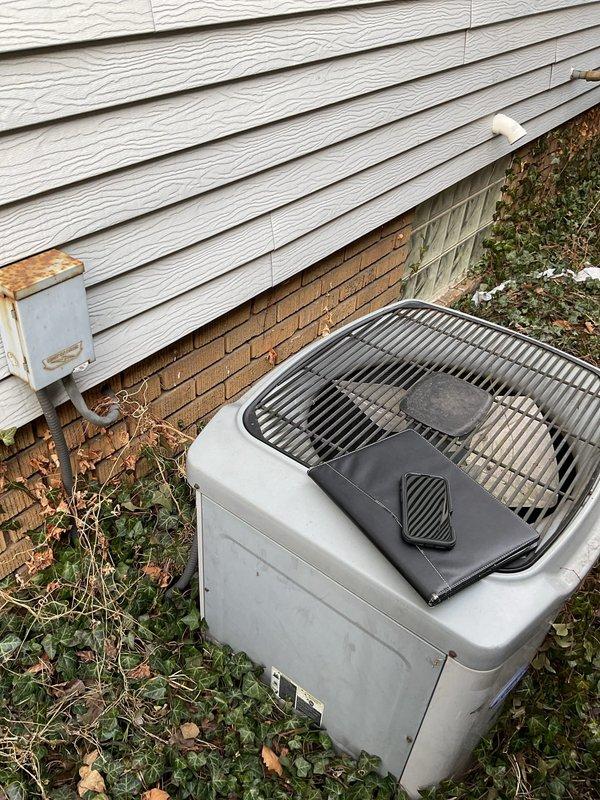Conducted comprehensive site assessment for AC replacement quote, examining the existing outdoor unit (showing signs of weathering with rusted disconnect box) and the indoor HVAC system (Amana furnace with Carrier ductwork components). Evaluated current installation configuration including condensate drainage, electrical connections, and integration with the home's water heating system to determine optimal replacement specifications.