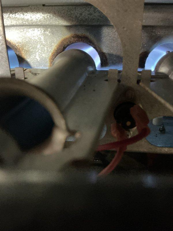 Performed routine maintenance on 10-year-old furnace. Replaced heavily clogged air filter (25x37x7) which showed significant dust accumulation. Inspected burner assembly and verified proper flame characteristics with normal blue coloration, indicating complete combustion and normal operation.