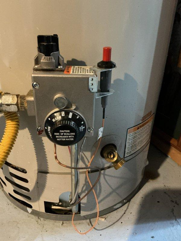 Responded to service call for water heater failing to maintain flame. Inspected unit and found visible blue flame through viewing port after repair. Serviced control panel components including temperature dial and gas connections, restoring proper ignition and operation of the tanked water heater.