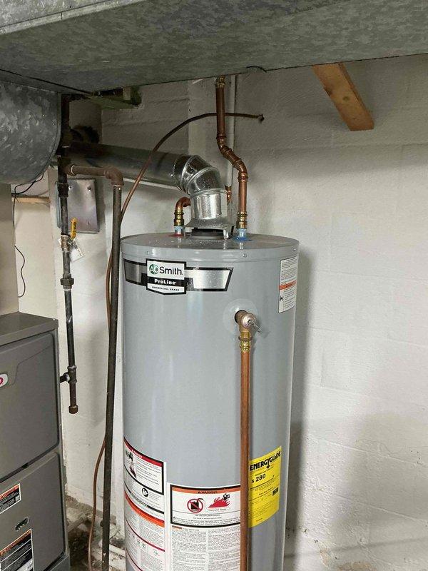 Performed comprehensive furnace maintenance service on residential HVAC system adjacent to A.O. Smith ProLine water heater. Inspected all furnace components, cleaned critical elements, and verified proper operation of heating system for optimal efficiency and safety.