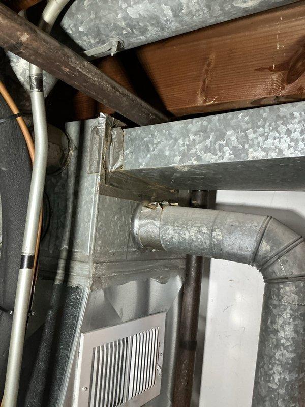 Responded to emergency service call for non-functioning blower in a 2-3 year old furnace. Inspected electrical connections at the control board, finding properly terminated wiring with red connectors. Observed operational gas burners with characteristic blue flame, indicating proper combustion. Verified ductwork integrity and airflow path was unobstructed with no visible damage to the ventilation system.