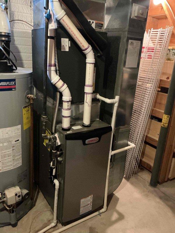 Performed scheduled furnace maintenance in basement mechanical room. Inspected Lennox furnace system with proper PVC venting, confirmed water heater (Powerflex) was operating normally, and verified all connections were secure. No issues found during tune-up service.