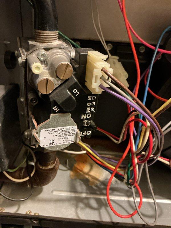 Performed routine furnace maintenance on 10-year-old heating system. Inspected electrical connections and gas valve assembly for proper operation, confirming all wiring (red, blue, green, purple, white) was securely connected to control board. Verified proper function of gas valve and documented condition with diagnostic photos.