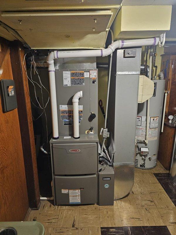 Successfully installed a complete 16 SEER 3-ton 2-stage Lennox split gas system with 90kBTU 96% efficiency furnace in residential mechanical room. Installation included 17-gallon humidifier, 5" filter rack (16x25x5), approximately 50' of new venting, new lineset, new pad, electrical disconnect, and Honeywell T6 Pro thermostat. System was properly connected with PVC ventilation and all components were verified operational before completion.