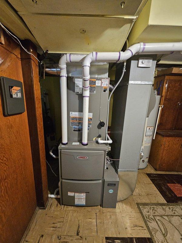 Successfully installed a complete 16 SEER 3-ton 2-stage Lennox split gas system with 90kBTU 96% efficiency furnace in residential mechanical room. Installation included 17-gallon humidifier, 5" filter rack (16x25x5), approximately 50' of new venting, new lineset, new pad, electrical disconnect, and Honeywell T6 Pro thermostat. System was properly connected with PVC ventilation and all components were verified operational before completion.
