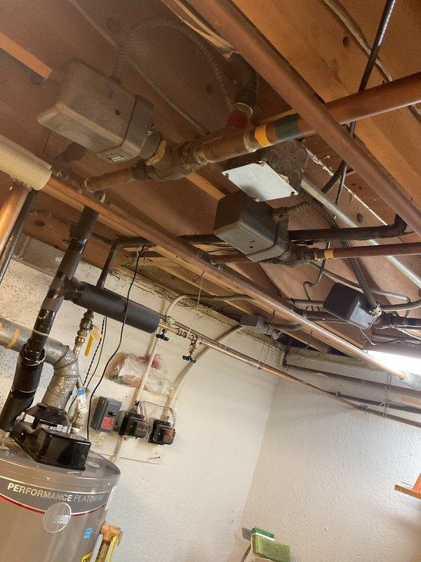 Completed comprehensive inspection of aging boiler system and associated zone valves in basement utility area. Documented existing conditions including deteriorated copper piping, outdated expansion tank, and potential ventilation issues. Estimate prepared for full replacement of boiler unit and zone valves to restore system efficiency and reliability.