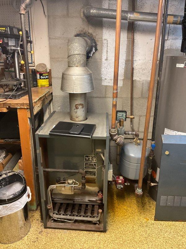 Completed comprehensive inspection of aging boiler system and associated zone valves in basement utility area. Documented existing conditions including deteriorated copper piping, outdated expansion tank, and potential ventilation issues. Estimate prepared for full replacement of boiler unit and zone valves to restore system efficiency and reliability.