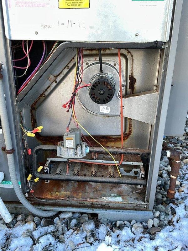 Returned to property to complete scheduled inducer motor replacement in aging furnace system. Successfully installed new inducer motor, resolving operational issues that were evident from significant rust and corrosion observed throughout the heat exchanger and lower components. System now functioning properly with all connections secured and tested.