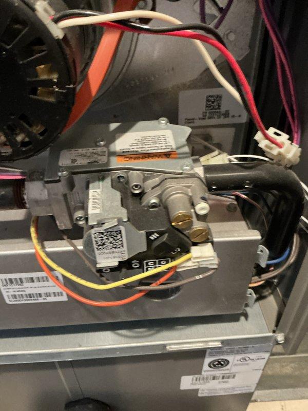 Performed scheduled furnace maintenance on natural gas heating system. Conducted complete diagnostic testing including electrical measurements with clamp meter, showing 24.7 amps on control board. Inspected gas valve assembly and connections, verified proper operation of all components with no issues detected.