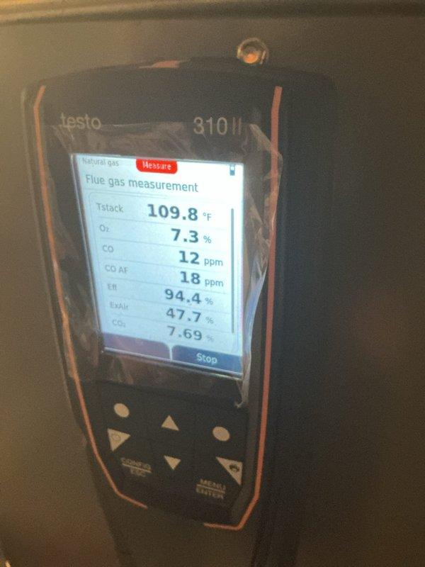 Performed a heating maintenance tune-up as first call of the day. Observed significant corrosion/rust on metal components of the unit, indicating possible water damage or fluid leakage. Conducted combustion analysis with Testo 310 II analyzer showing satisfactory readings: 94.4% efficiency, CO at 12 ppm, and stack temperature at 109.8°F.