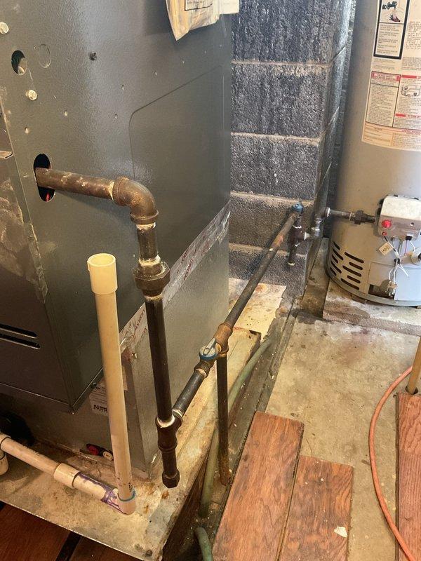 Completed chimney liner replacement and installed new flue pipe connecting to furnace and water heater. Repaired gas line connections to both appliances, ensuring proper venting and safe operation of the heating system.