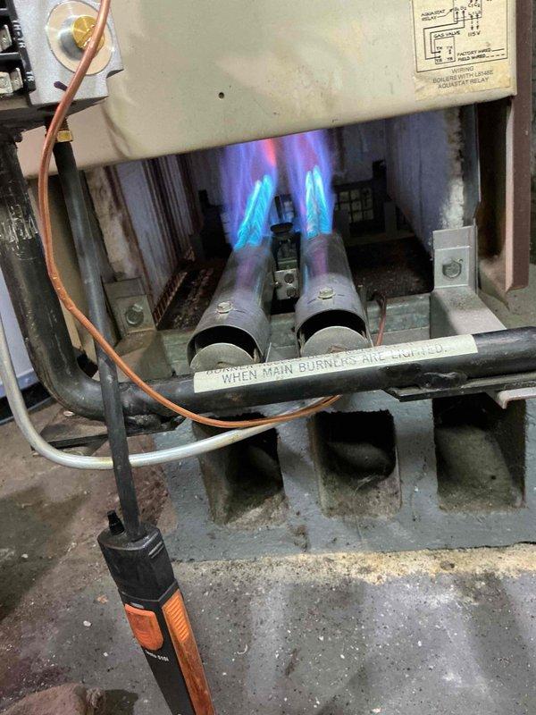 Responded to callback for no heat on a hydronic boiler system. Inspected unit and verified burners were lighting properly with strong blue flames. System is now operating normally with all safety controls functioning as designed.
