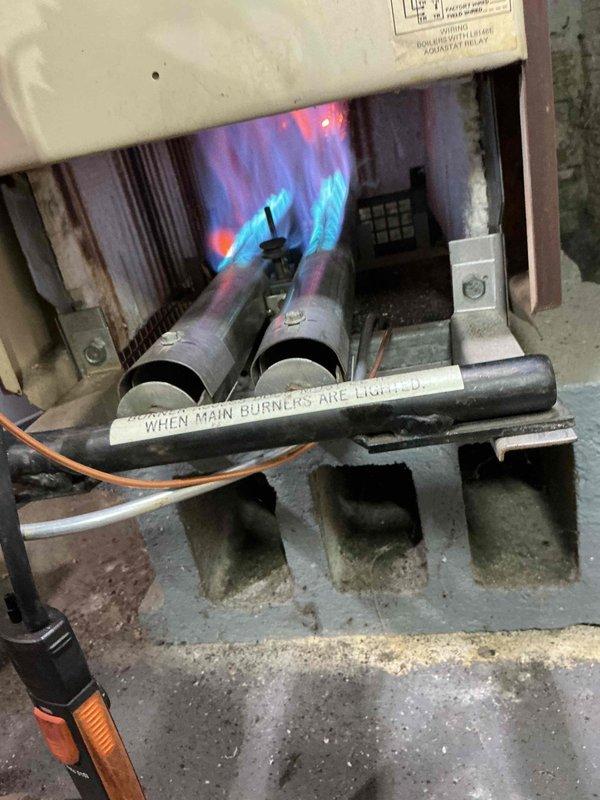 Responded to callback for no heat on a hydronic boiler system. Inspected unit and verified burners were lighting properly with strong blue flames. System is now operating normally with all safety controls functioning as designed.