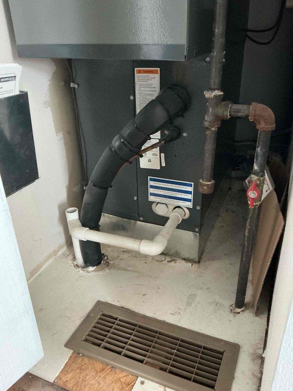 Responded to no-heat call at residential property. Inspected furnace system located in utility closet with associated ductwork and ventilation components. Diagnosed and restored heating functionality by clearing obstructed condensate drain line and resetting system safety switch. Verified proper operation of all heating components and confirmed adequate airflow through return vents before completing service.