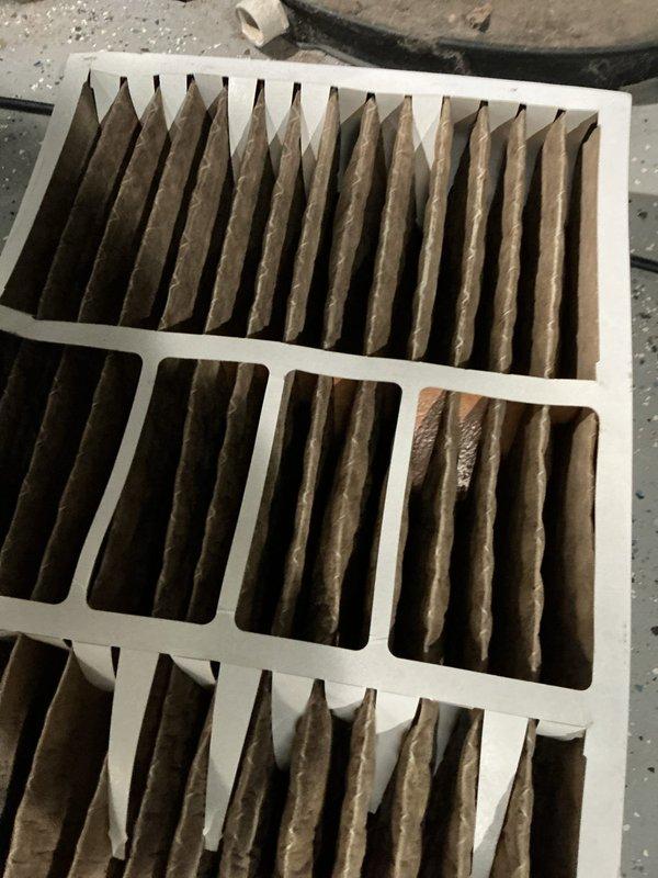 Responded to no-heat call for furnace of undetermined age. Inspection revealed heavily soiled air filter as primary issue, with significant dust and debris accumulation on the pleated filter elements. Replaced contaminated filter with new standard HVAC system filter to restore proper airflow and system operation.