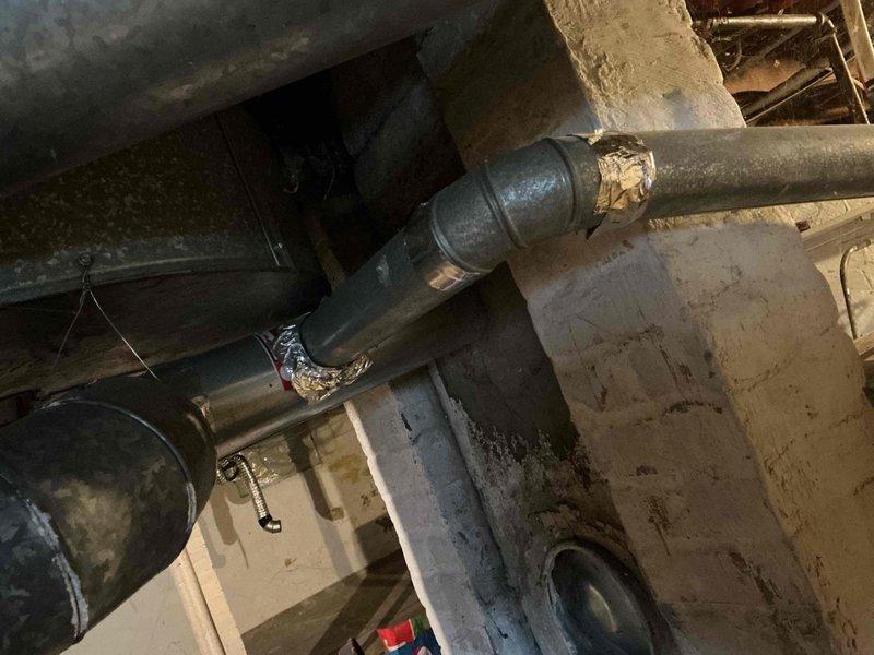 Responded to no-heat call for 15-year-old gas furnace that had ceased operation. Inspection of ductwork and ventilation system revealed significant dust accumulation and wear on galvanized steel components. Identified and repaired compromised joint connection in the drainage system, which had been previously addressed with temporary sealing materials.