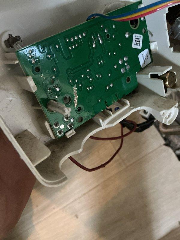 Diagnosed and serviced Honeywell control unit on tanked water heater that was not producing hot water. Inspection revealed circuit board issues and compromised wiring connections within the control module. Repaired exposed wire connections and cleaned corrosion from metal components to restore proper functionality.
