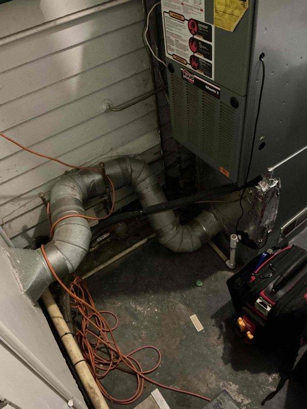 Responded to service call for a less than one-year-old gas furnace not producing heat in a crawlspace installation. Inspection revealed disconnected ductwork, likely caused by animal intrusion similar to previous raccoon damage. Reconnected and properly secured all ductwork connections, and verified proper system operation with normal heat output restored.