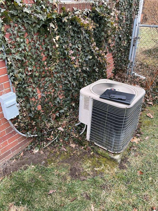 Conducted comprehensive AC replacement assessment of residential HVAC system, including inspection of existing furnace with PVC ventilation and connected ductwork. Evaluated older outdoor condenser unit positioned against ivy-covered brick exterior wall, documenting current condition and specifications for appropriate system matching. Photos taken of mechanical room configuration and outdoor equipment to support accurate replacement proposal.