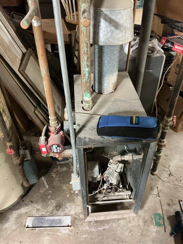 Responded to service call for non-functioning water boiler over 18 years old. Inspection revealed a circulation pump with significant corrosion on copper piping and green patina formation. Replaced failing circulation pump, cleaned mineral deposits, and verified proper system operation with all connections secure.