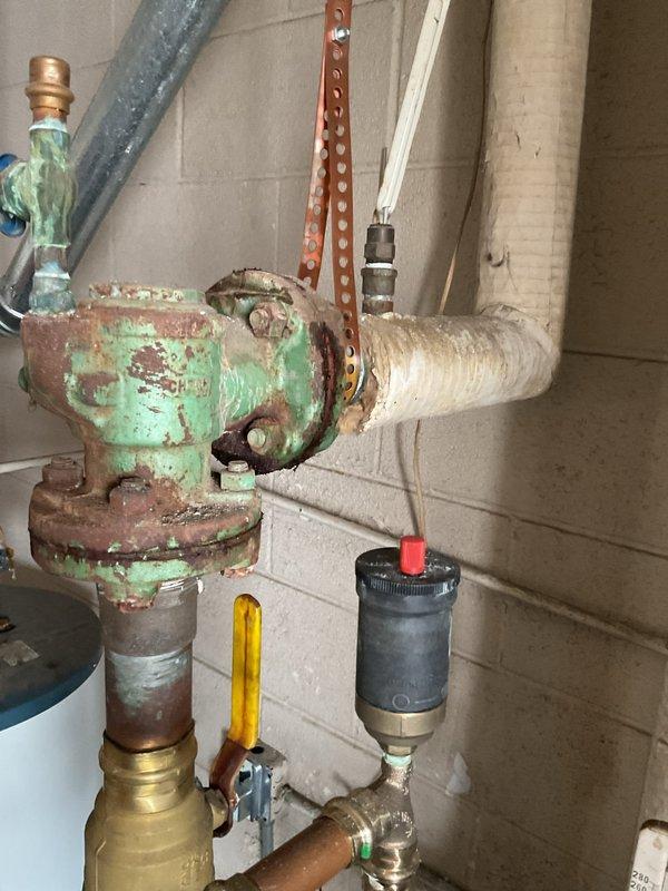 Conducted comprehensive assessment of existing boiler system, documenting severe corrosion on primary valve assembly and deterioration of associated piping infrastructure. Recommended replacement of corroded components and installation of modern high-efficiency unit with digital control interface to prevent potential system failure and improve operational efficiency.