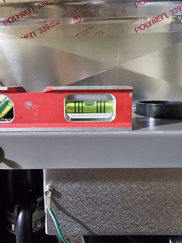 Successfully installed a Lennox Elite 2-stage furnace with proper leveling confirmed using spirit level. System includes new Honeywell WiFi thermostat and features properly sealed metallic ductwork connections with Polyken 339 tape at all seams. PVC drainage system was installed with appropriate routing from unit to floor drain.