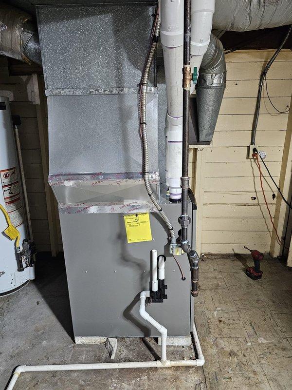 Successfully installed a Lennox Elite 2-stage furnace with proper leveling confirmed using spirit level. System includes new Honeywell WiFi thermostat and features properly sealed metallic ductwork connections with Polyken 339 tape at all seams. PVC drainage system was installed with appropriate routing from unit to floor drain.