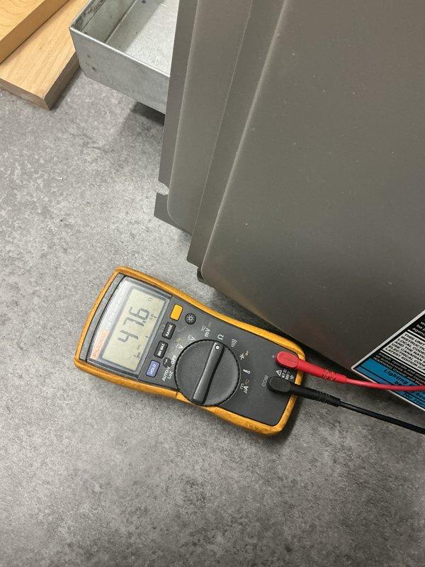 Performed dual furnace maintenance service with comprehensive electrical testing. Conducted voltage measurements on system components with readings of 9.43V and 47.5V observed on digital multimeters. Customer expressed interest in maintenance membership program for future service.
