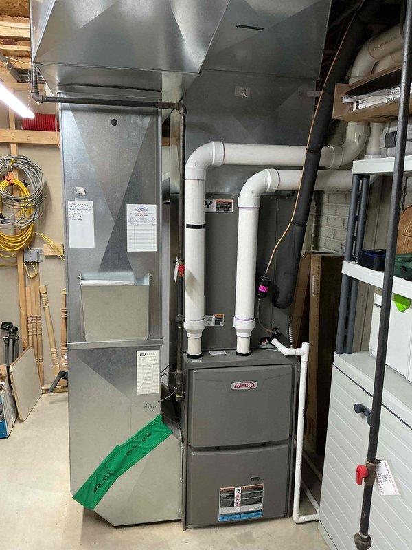 Performed annual furnace maintenance service on Lennox heating system located in basement. Inspected air handler, heat exchanger, and PVC exhaust/intake components, all in working order. Identified noisy fan issue with water heater; diagnostic assessment completed and repair quote provided to customer.