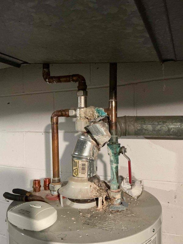 Performed routine furnace maintenance service and inspected customer's water heater which showed significant mineral deposits and corrosion on copper pipes and fittings. Documented buildup around pipe connections and pressure release valve, noting the aged condition of plumbing components. Customer was provided with recommendations for addressing the deteriorating vent in bedroom as requested.
