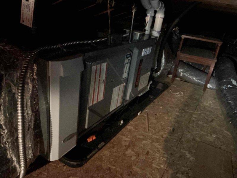 Performed scheduled maintenance on furnace unit located in attic space. Inspected interior components including blower motor assembly, gas valve, wiring harness, and drainage system; all components found in normal operating condition. Documentation photos taken of complete system installation and internal components for service records.