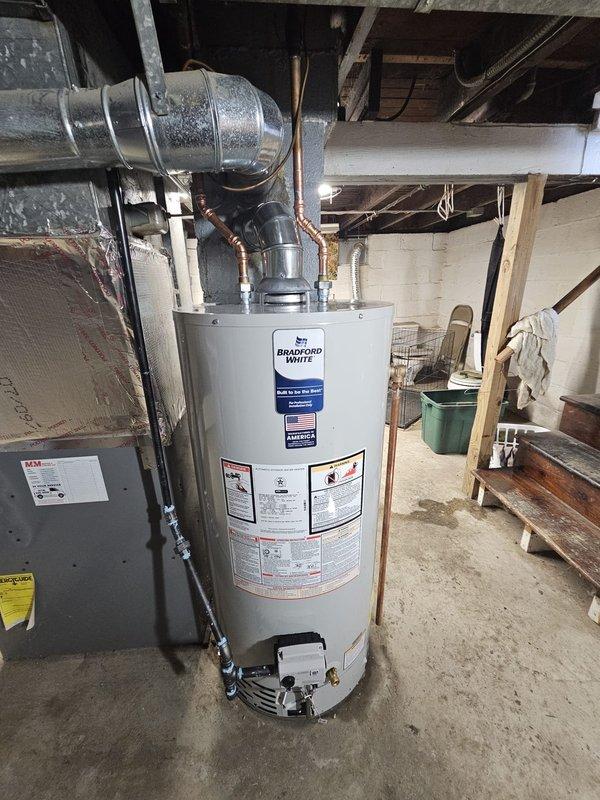 Successfully installed a 40-gallon Bradford White gas water heater in the basement utility area. Connected new copper piping to the unit and properly installed metal ventilation ductwork with appropriate insulation. All connections were tested and confirmed operational before completing the job.