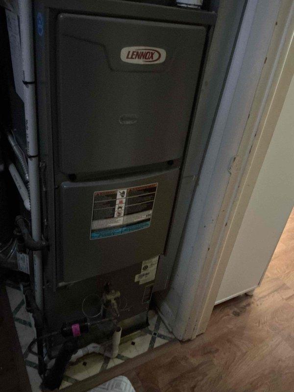 Performed routine air conditioning maintenance on Lennox HVAC system. Inspected furnace unit in utility closet and examined outdoor condenser unit, which showed significant dirt buildup and weathering. Noted capacitor connections and electrical components were intact, though exterior of condenser requires cleaning to improve system efficiency.